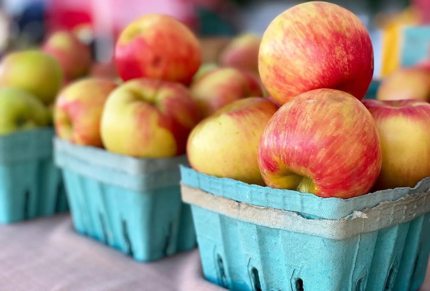 A table with apple produce on it.